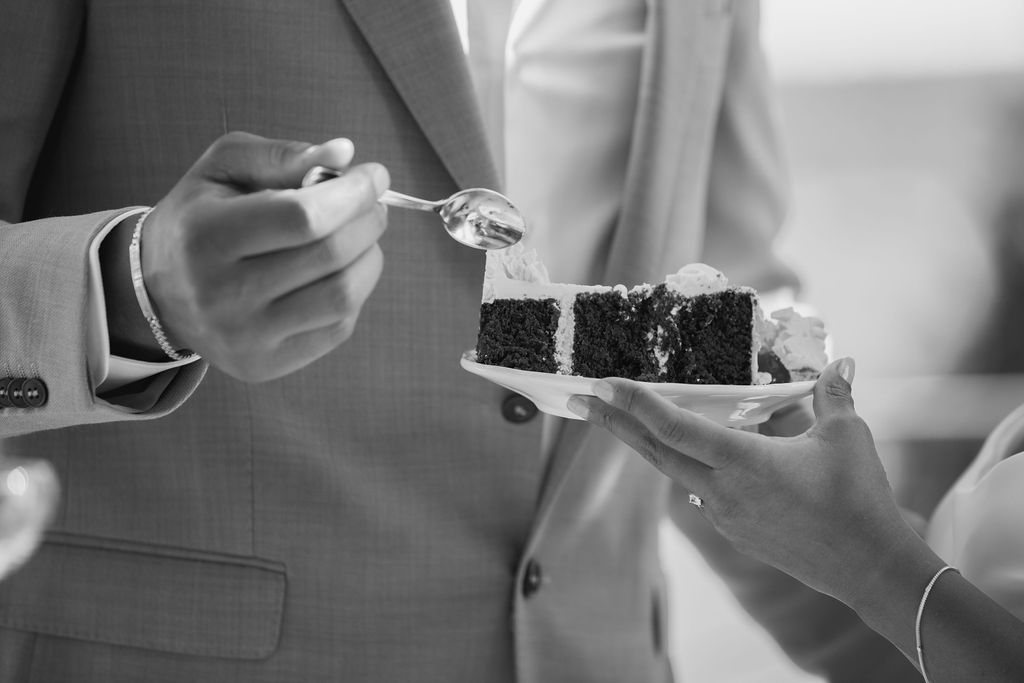 En lyxig tårtbit serverad med en sked på en tallrik som dessert efter en lyckad mat bröllopsfest